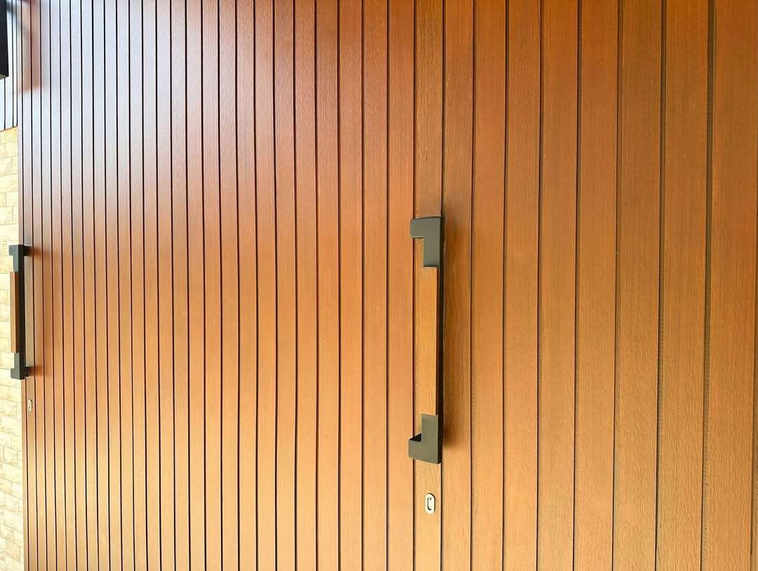 Woodium door with a vertical plank pattern