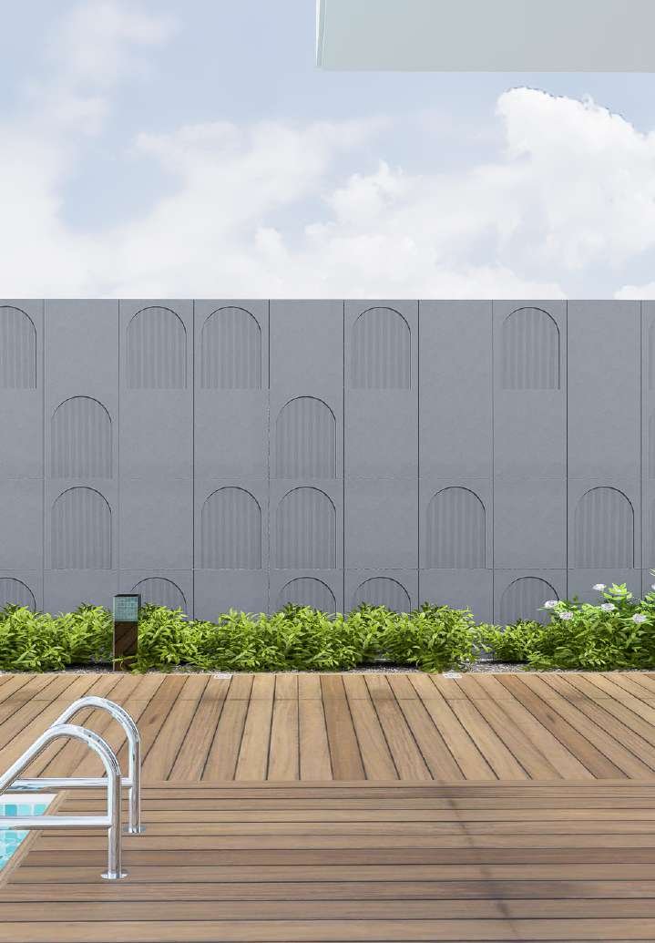 Sculpted arch-pattern Woodium panels on a poolside boundary wall