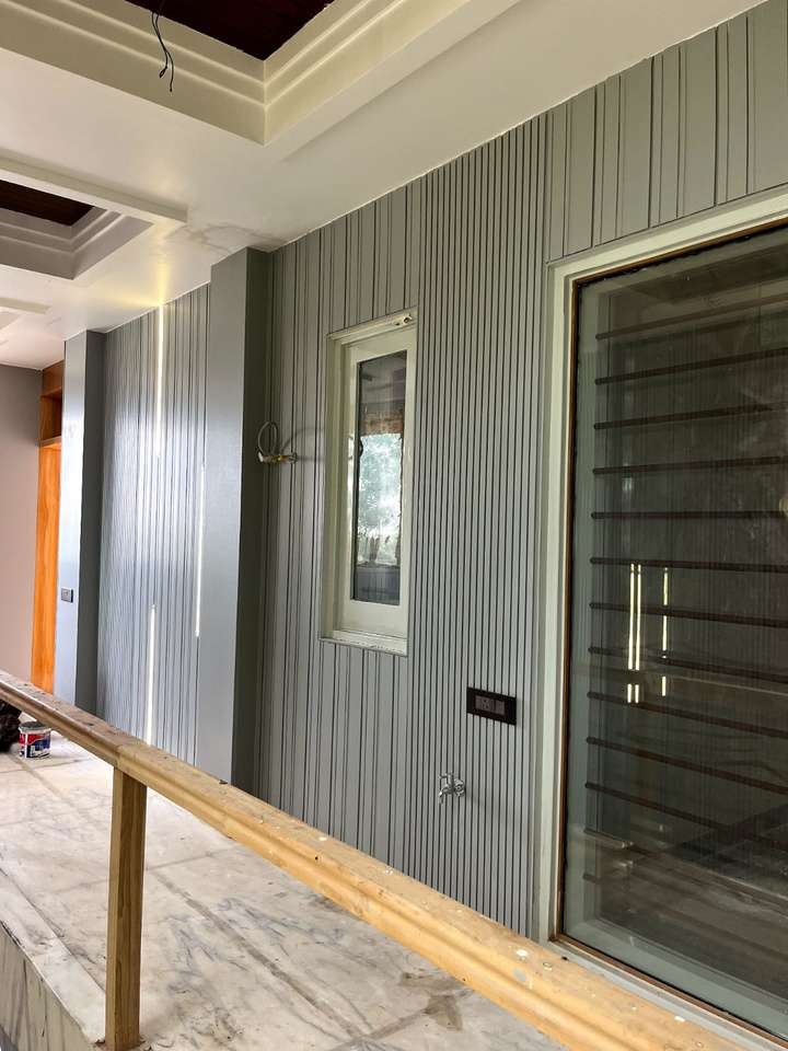 Grey Woodium planks on a corridor wall beside a glass door