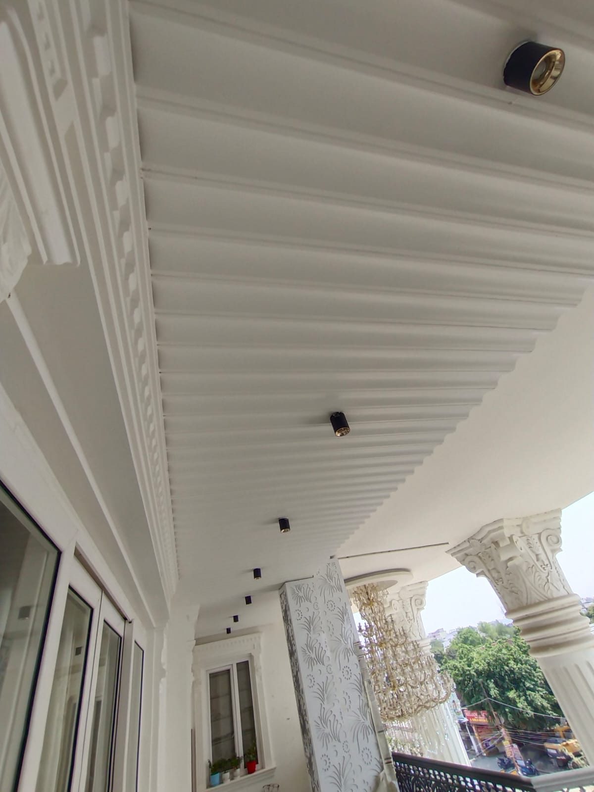 Painted Woodium ceiling under a balcony