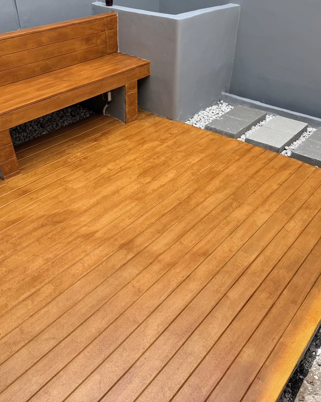 Woodium deck with a built-in bench